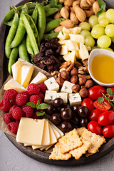 Cheese plate with fresh vegetables and fruits