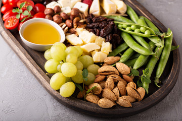 Cheese plate with fresh vegetables and fruits