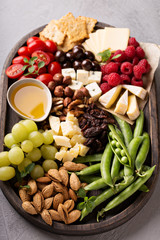 Cheese plate with fresh vegetables and fruits
