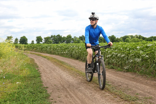 cyclist rides along a field trail