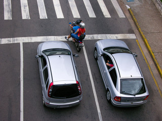 two silver cars and a motorcycle from above