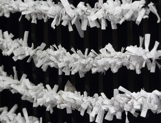 Symbols of japanese shinto - paper strips with random fortunes (omikuji)