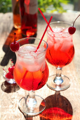 Glasses with tequila cocktails on blurred background