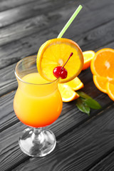 Glass of delicious tequila sunrise cocktail on table