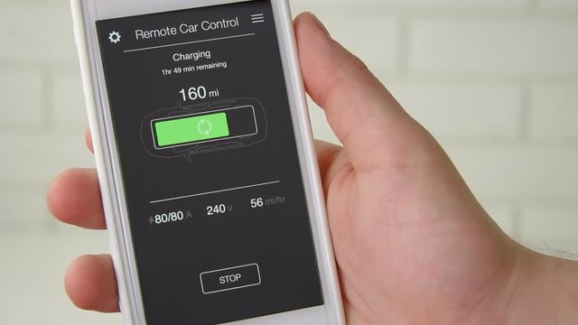 Man checks charge level of his car. Charging in progress Car remote control using smartphone application fictional interface.