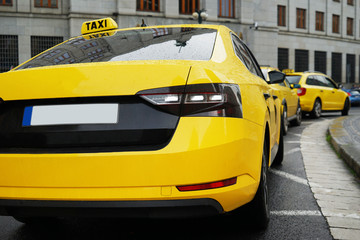 Rear view of yellow taxi on street