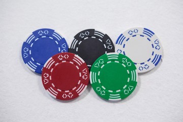 Casino chips arranged on white background