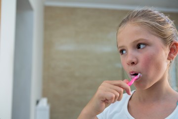 Close up of girl brushing teeth