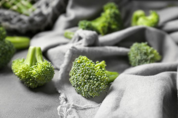 Tasty fresh broccoli on grey cloth, closeup