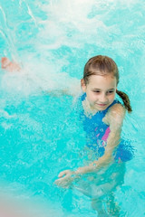 Fototapeta na wymiar A child swims in the pool.