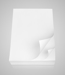Stack of white paper with curled corner on gray background with clipping path