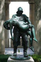 sculpture of a man holding a woman / fisher saving near drown girl statue