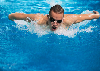 Fototapeta na wymiar Male swimmer at the swimming pool. Underwater photo