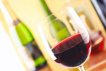 Glass of wine and a bottle on black background