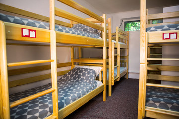 Interior of the hostel bedroom. Hostel with wooden bunk beds