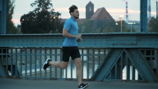 Handsome, ambitious jogger running throughout the city