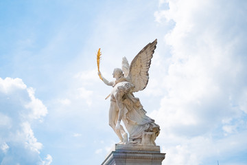 Fototapeta na wymiar Angel statue with heaven / cloud sky background