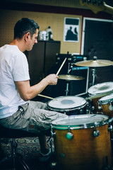 Behind scene. Drummer artist musician playing the drums with drumsticks