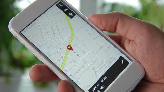 Man checks his car location using mobile device. Car remote control using smartphone application fictional interface.