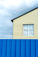 House Exterior and Window with Blue Fence