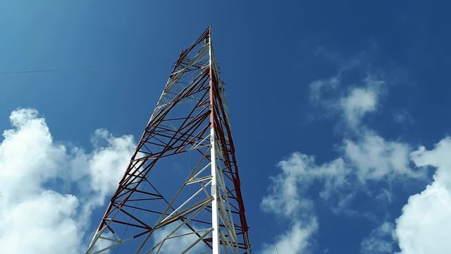a timelapse or hyperlapse of 3 erectors or riggers working at height for installation of tower members for telecommunication projecct.