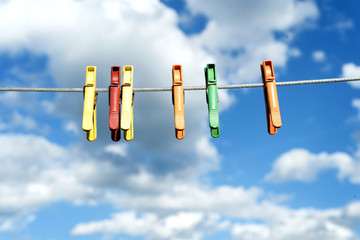 Assorted Bright Plastic Clothes Pegs on a Washing Line