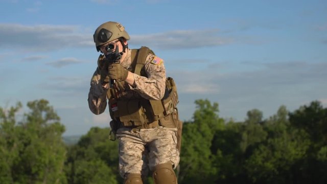 Armed man taking aim. Airsoft Slow motion