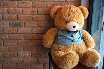 Teddy Bear Red brick wall background