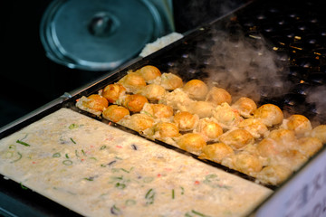 Takoyaki is a ball-shaped Japanese snack made of a wheat flour-based batter and cooked in a special moulded pan.