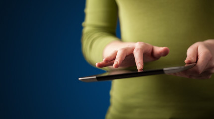 Close up of hand holding digital touchpad tablet device