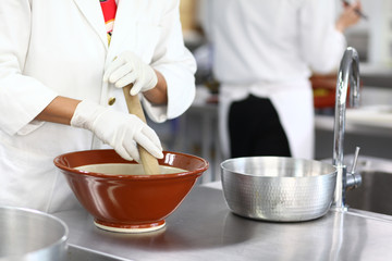 Japanese food preparation in white kitchen