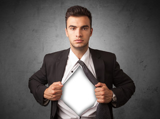 Businessman tearing off his shirt with white copyspace on chest