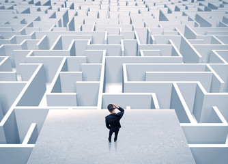 Businessman staring at infinite maze