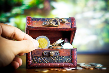 Saving money concept preset putting money coin stack growing business on bright light glowing bokeh background, business finance wealth and success concept.