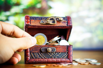 Saving money concept preset putting money coin stack growing business on bright light glowing bokeh background, business finance wealth and success concept.