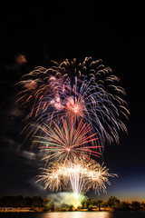 Stunning Fireworks above Lake in the Night