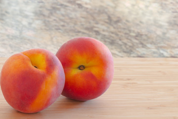  Ripe  peaches on cutting board.