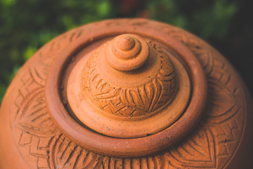 Closed up of orange baked clay pot,Clay pots for cooking outside a restaurant on background nature