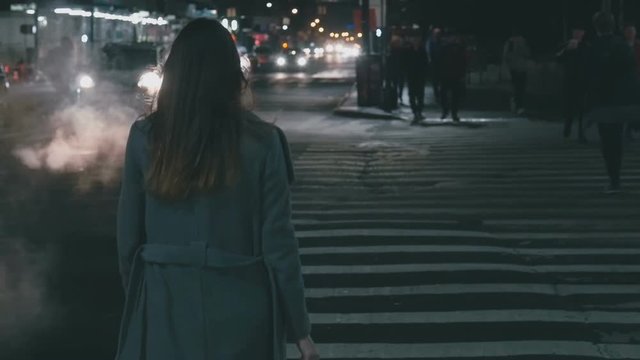 Girl is walking along the pedestrian crossing slow motion