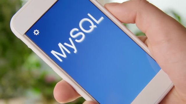 MySQL concept application on the smartphone. Man uses mobile app.