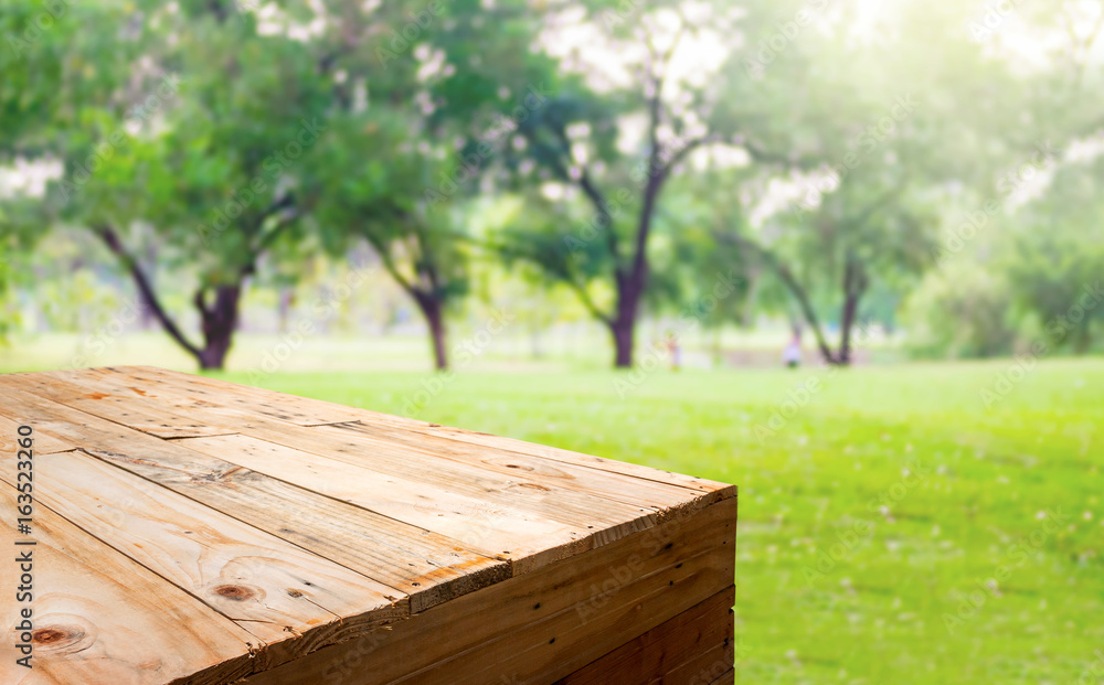 Aufkleber Empty wood plank table food stand with blur tree in park bokeh light background,Template mock up for display or montage of product.