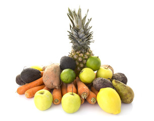 A pile of healthy fresh organic fruit and veg on a white background