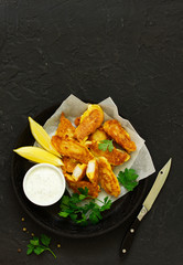Fish fried in a dough with white sauce.