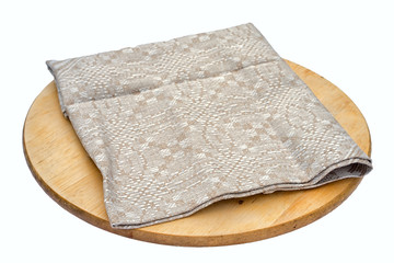 Crumpled beige linen sack burlap napkin on a round pizza board isolated on white background.