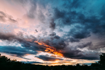 Dramatic gray and orange sunset on beautiful sky. Sky background on sunset with clouds