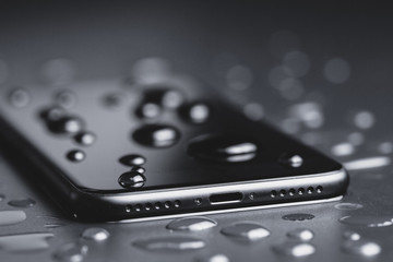 closeup phone be waterproof shot on black background