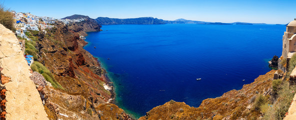 panoramic view on a bright Sunny day on Bay and sea cliff with height of Oia, Santorini, Greece
