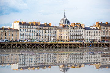 Obraz premium Beautiful riverside view with old buildings and Notre Dame cathedral in Nantes city in France