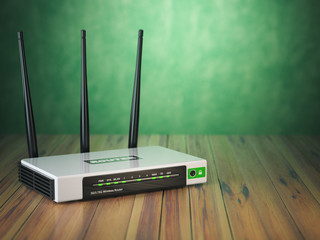 Wi-Fi wireless internet router on the wooden table and green background.