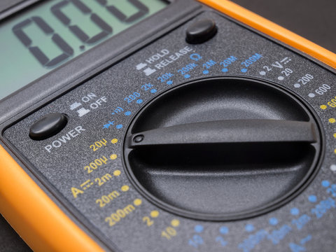 Multimeter and tester closeup on black background